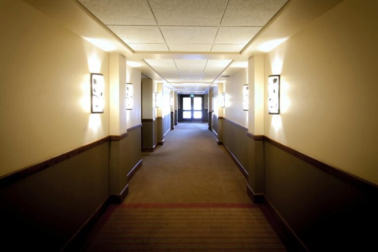 Bright hotel hallway in Boise, Idaho, showcasing elegant wall lighting and modern design.